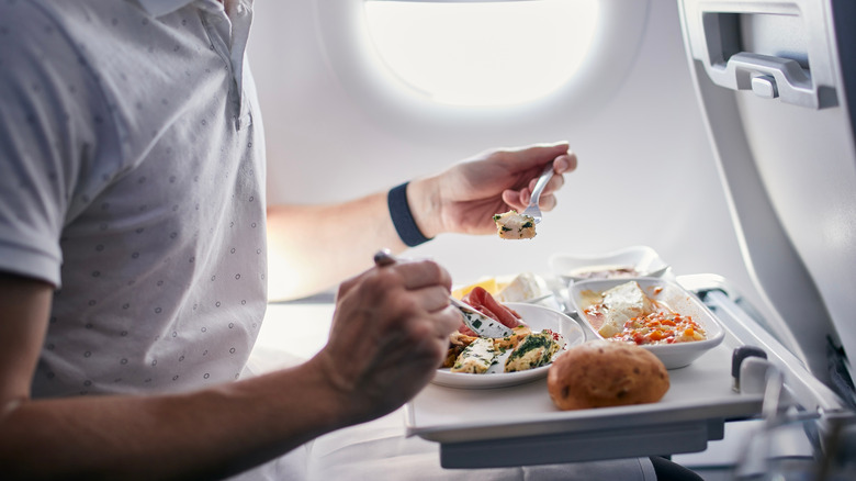 Passenger eating a meal on the plane