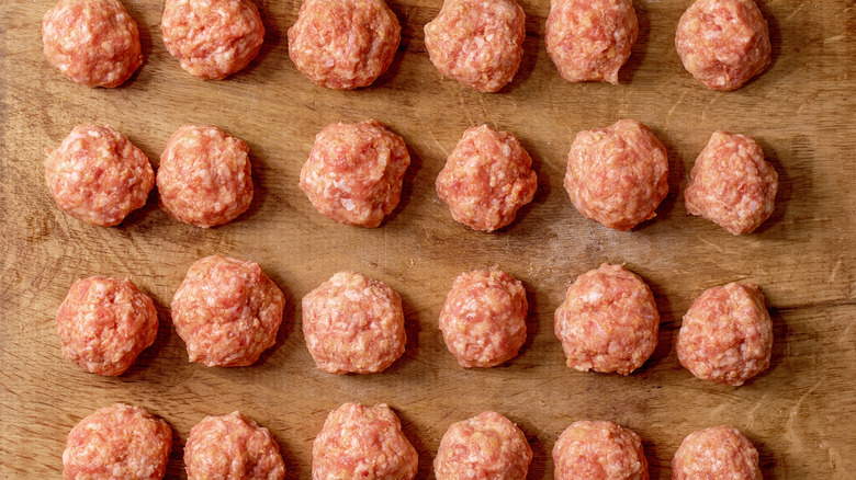 Rows of raw meatballs