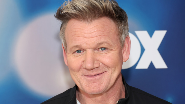 Gordon Ramsay smiles on an event red carpet