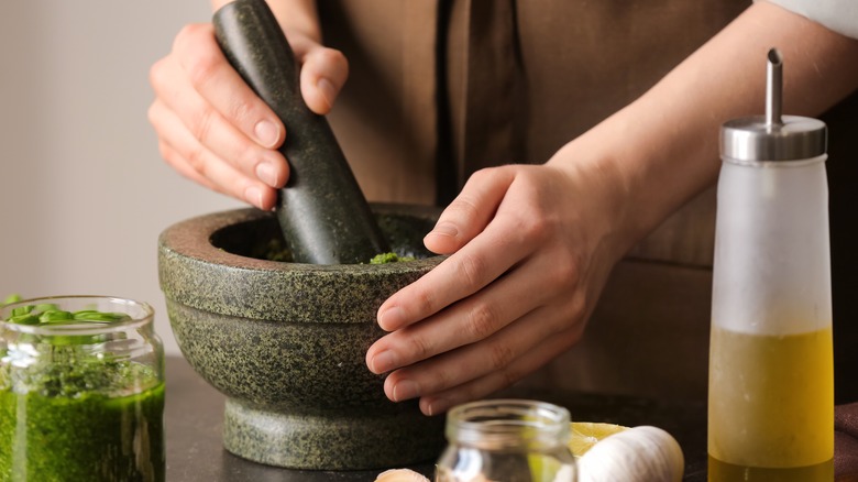 person using mortar and pestle