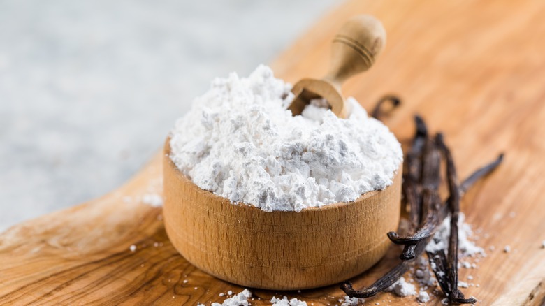 container of powdered sugar with a scoop