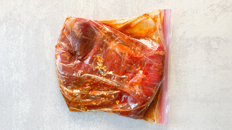 Flank steak marinating in ziplock bag