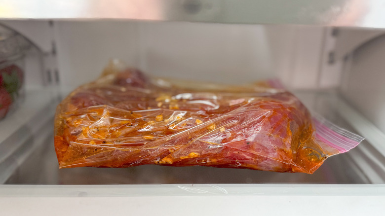 Flank steak marinating in ziplock bag in refrigerator