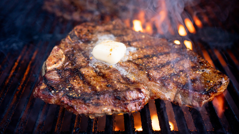 T-bone steak on grill grates