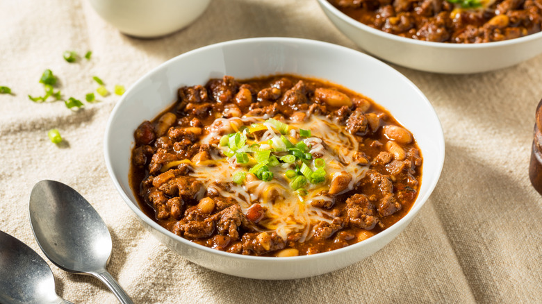 Bowl of turkey chili on table with spoon