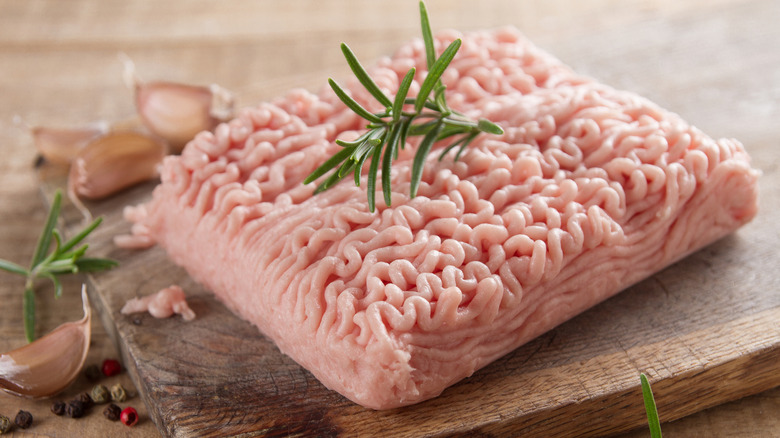 Ground chicken on cutting board with garnish