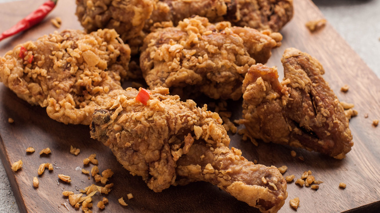 fried chicken on a wooden cutting board