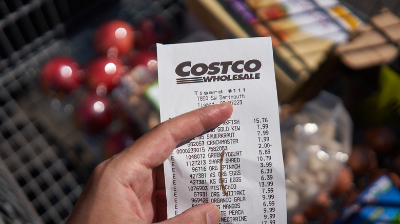 Person holding Costco receipt