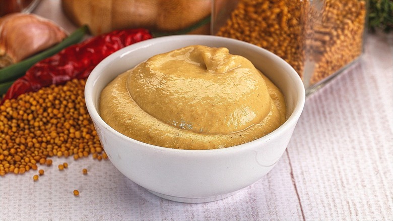 Dijon mustard in small white bowl