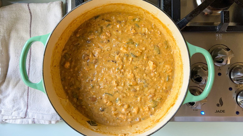 Hearty white chicken and navy bean chili in large pot on stovetop