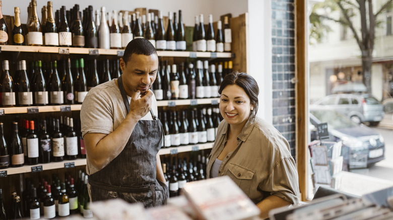 Merchant, customer in wine shop