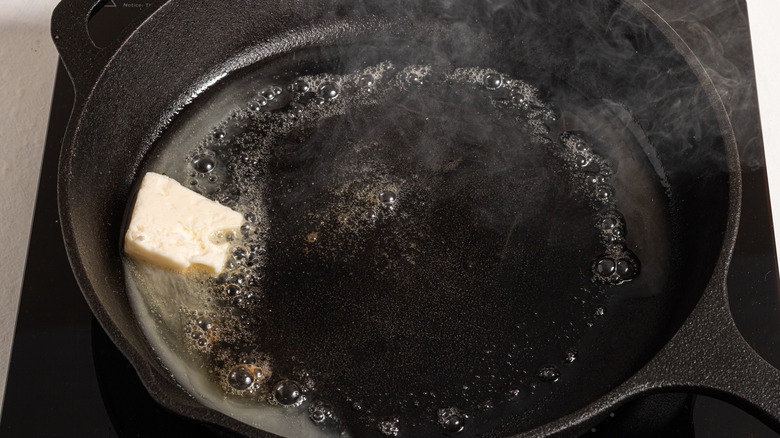 Hot cast iron skillet with butter melting inside