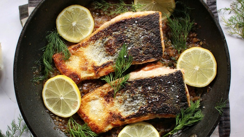 skillet of salmon fillets with lemons and dill