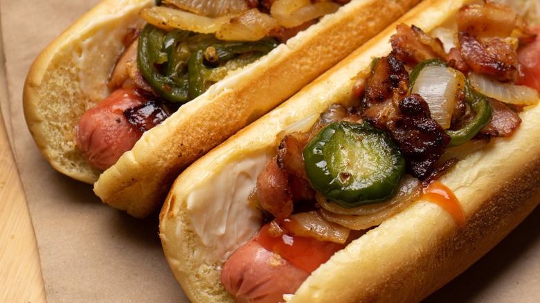 Hot dogs with grilled onions, bacon, and jalapeños