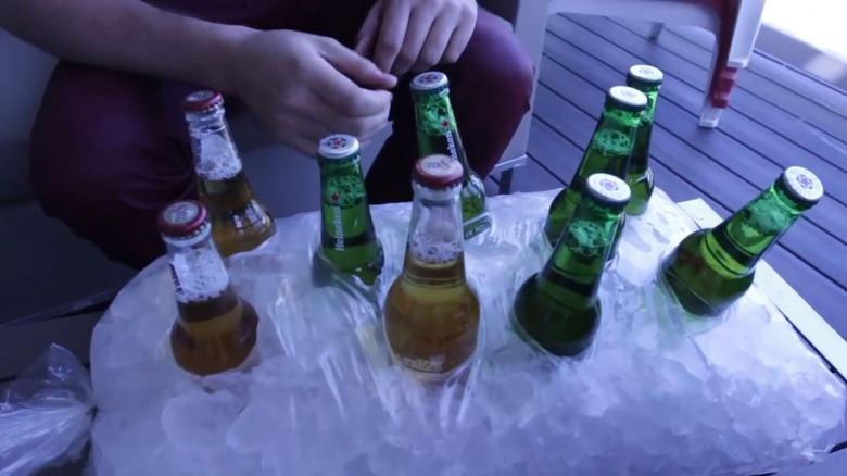 Beer nestled into plastic bag of ice