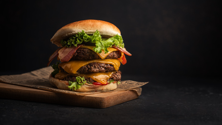 Cheeseburger against black background