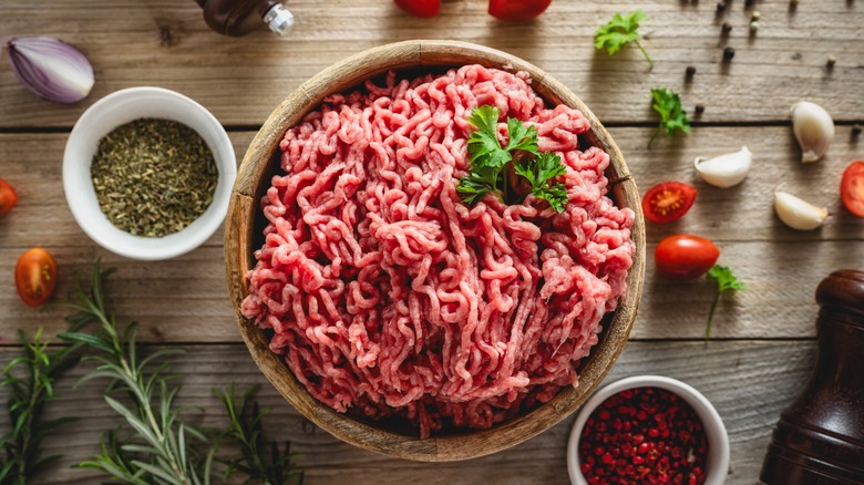 Fresh ground beef on wooden background