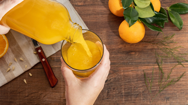 Pouring glass of orange juice