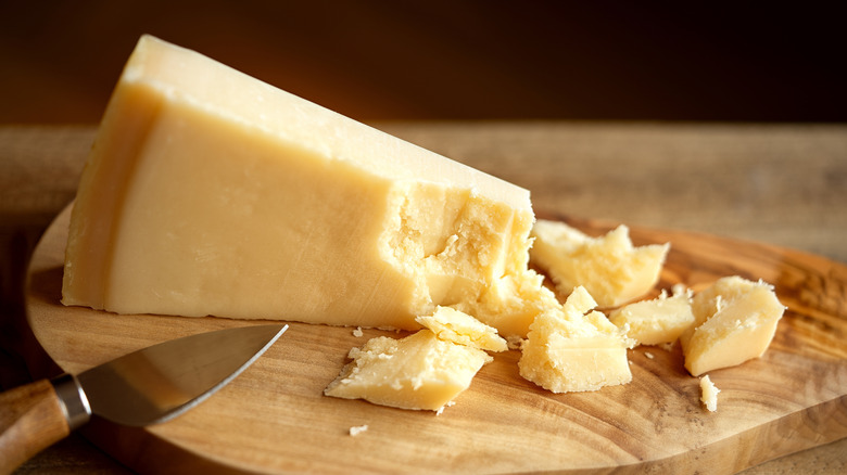 Parmesan cheese on a wooden cutting board