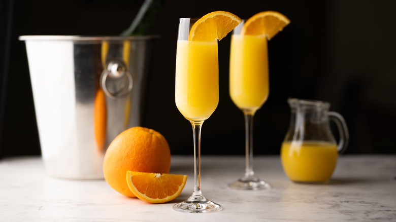 Two mimosa cocktails with orange slices