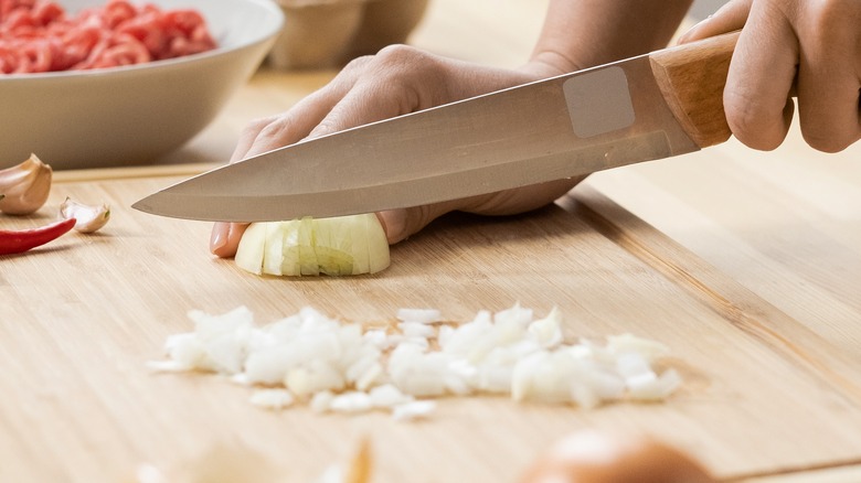 hand dicing onions