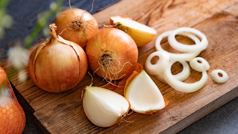 Cutting onions on a wooden board