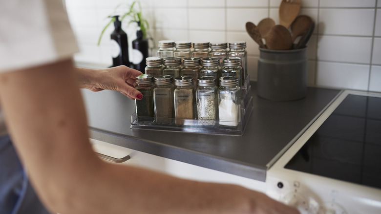 A woman grabs pepper