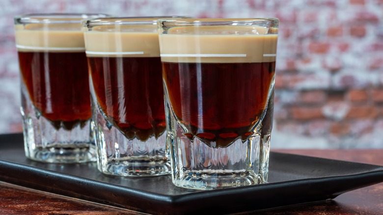 Dessert shots lined up on a serving platter