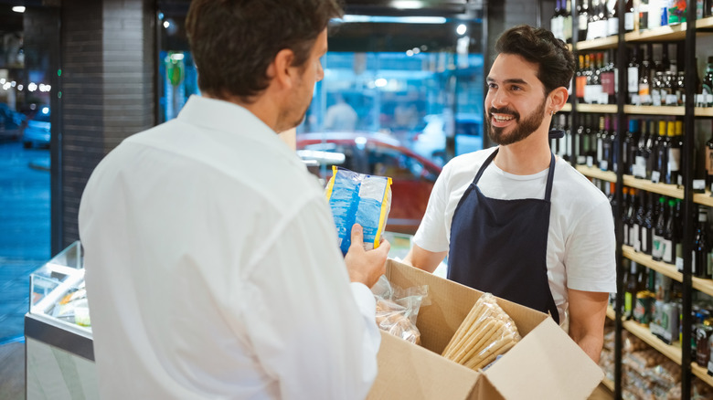 Person returning packaged food at counter