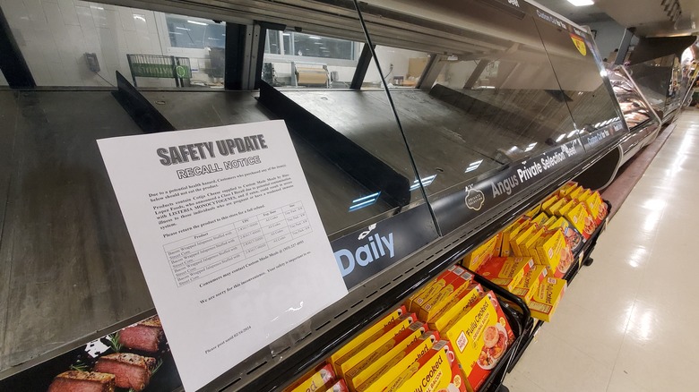 Empty display case with safety recall notice in window