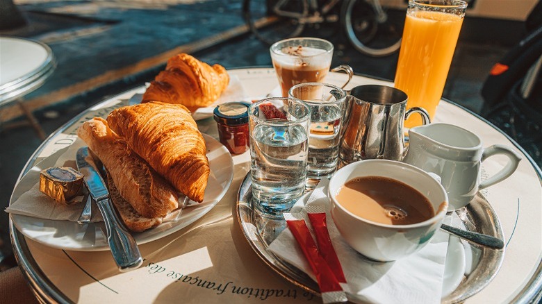 French croissants and coffee on outdoor table