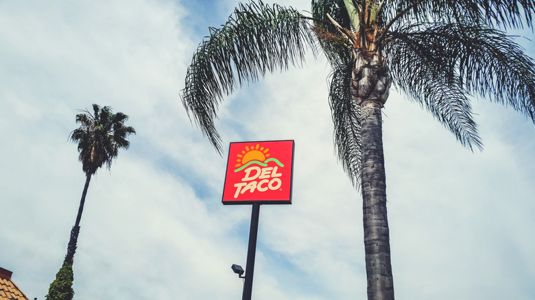 Del Taco sign and palm trees 