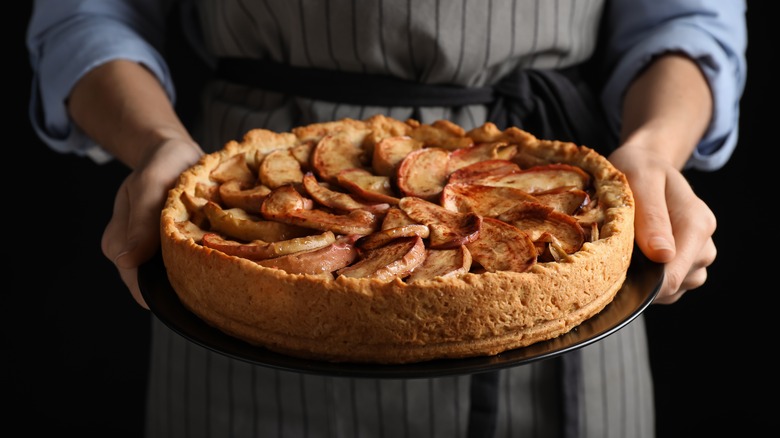 Woman holding apple pie