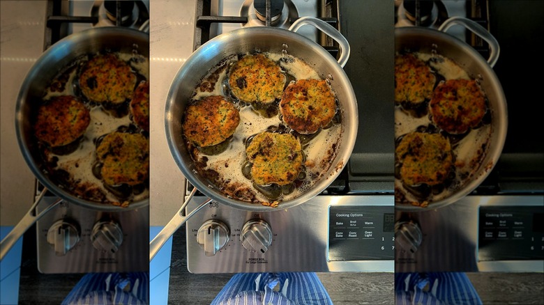 Breadcrumb patties frying in a pan