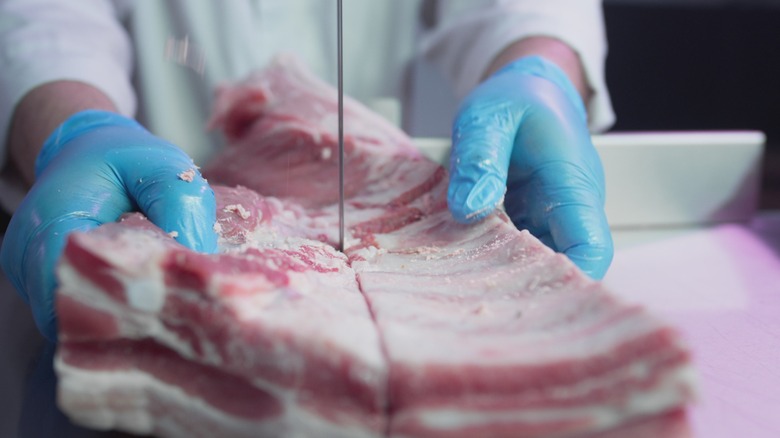 Raw tenderloin being processed