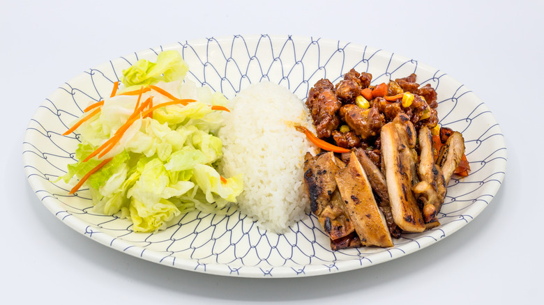 Teriyaki chicken served with rice and a salad