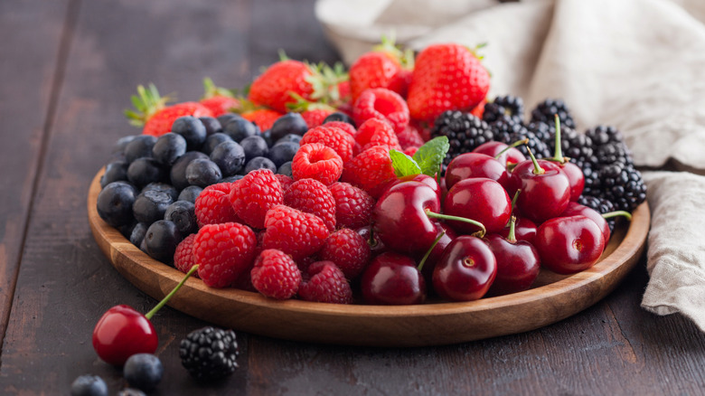 Summer berries on a wooden plate