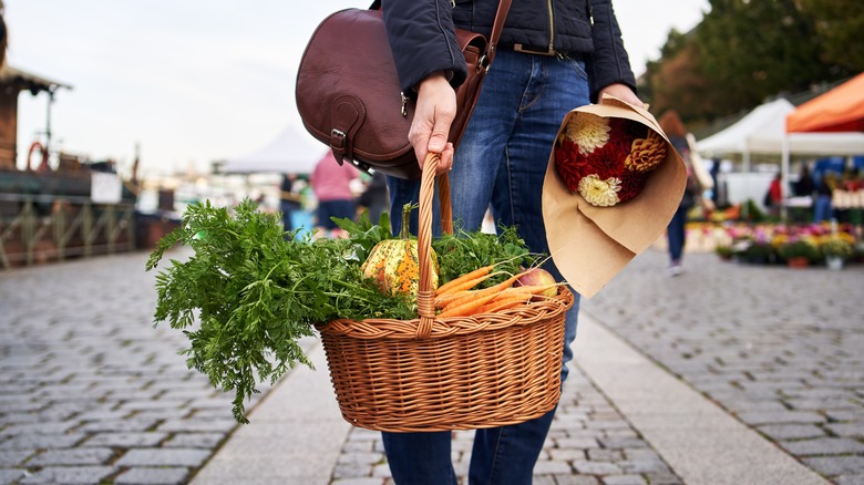 Hands holding produce in basket