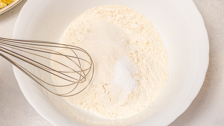 Whisking flour, sugar, and salt in a bowl