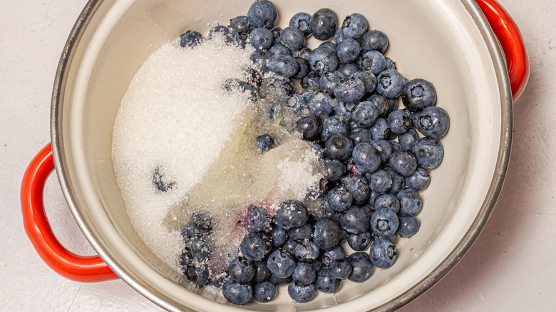 Saucepan with fresh blueberries, lemon juice, and sugar