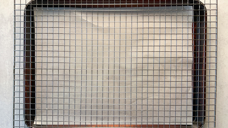 Baking sheet covered with parchment paper and a rack