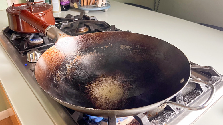 Oil heating in wok on stovetop