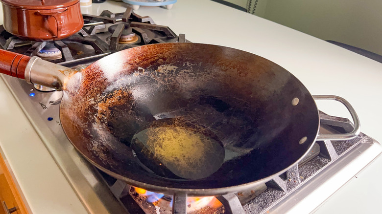 Avocado oil in wok on stove top