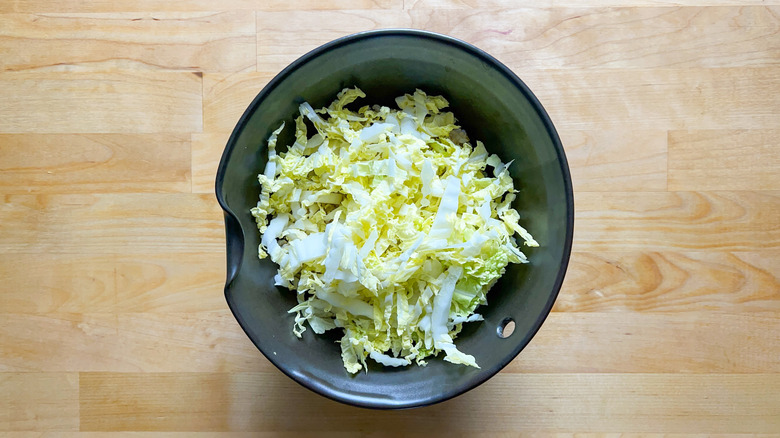 Napa cabbage in serving bowl over rice