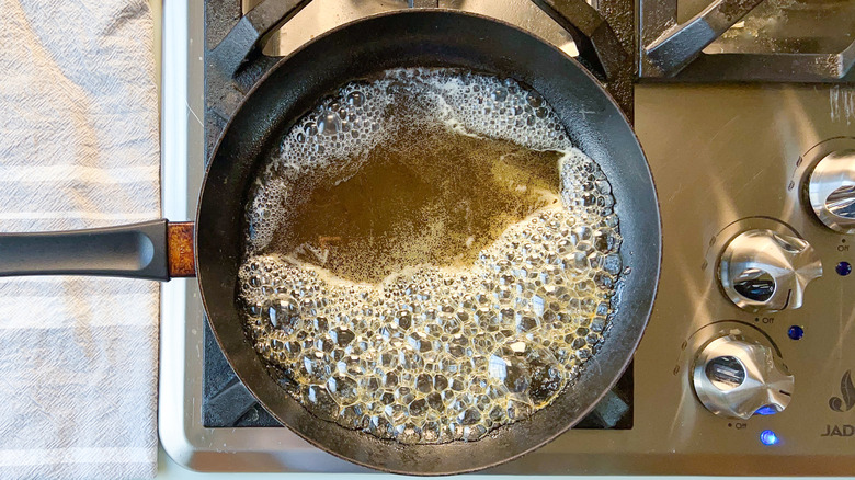 Honey and water boiling in skillet