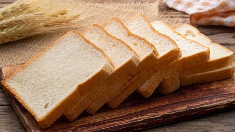 Slices of white sandwich bread on a cutting board