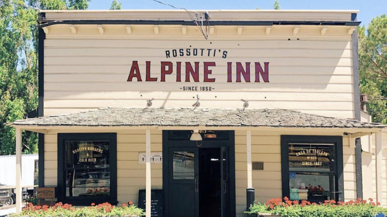 The front of Alpine Inn, surrounded by trees