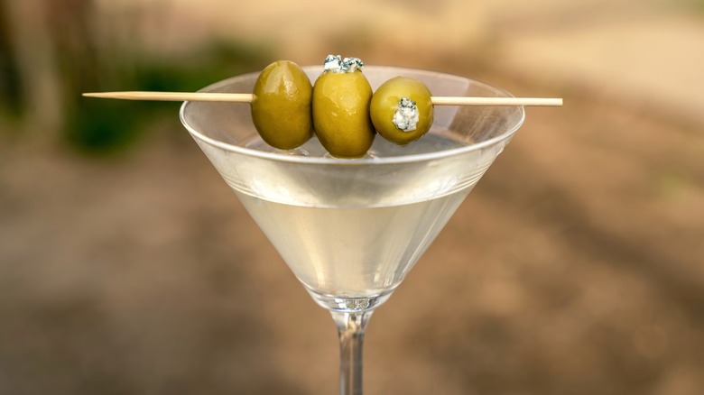 Martini garnished with blue cheese-stuffed olives on a stick