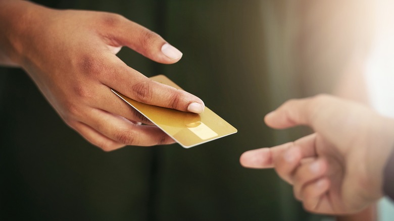 Person handing card to another