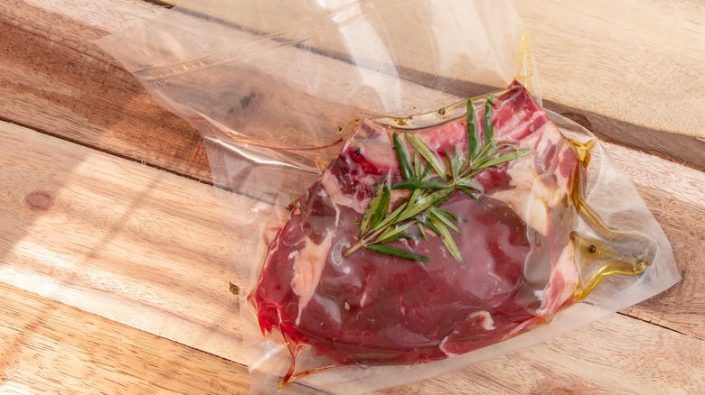 meat sealed in bag with rosemary